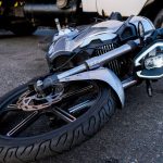 A damaged motorcycle laying on the ground